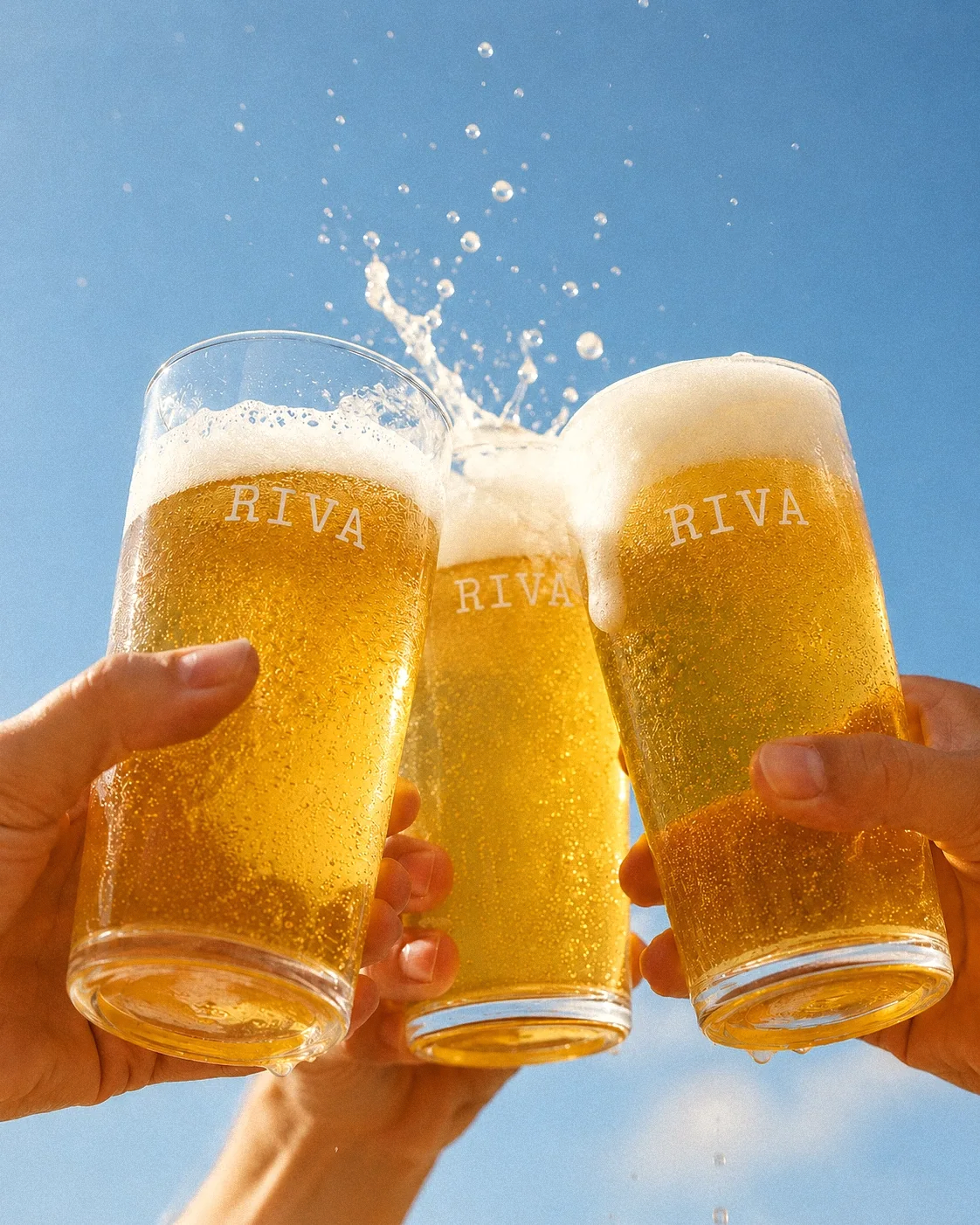Three Riva beer glasses raised in a toast